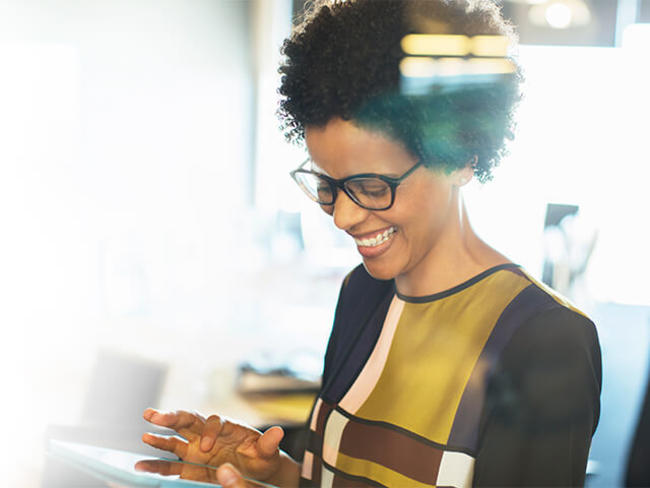 A woman reviews financial information on tablet device